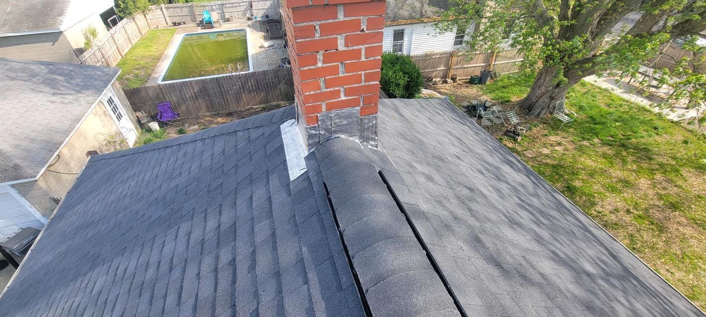 An aerial view of a roof with a chimney on it.
