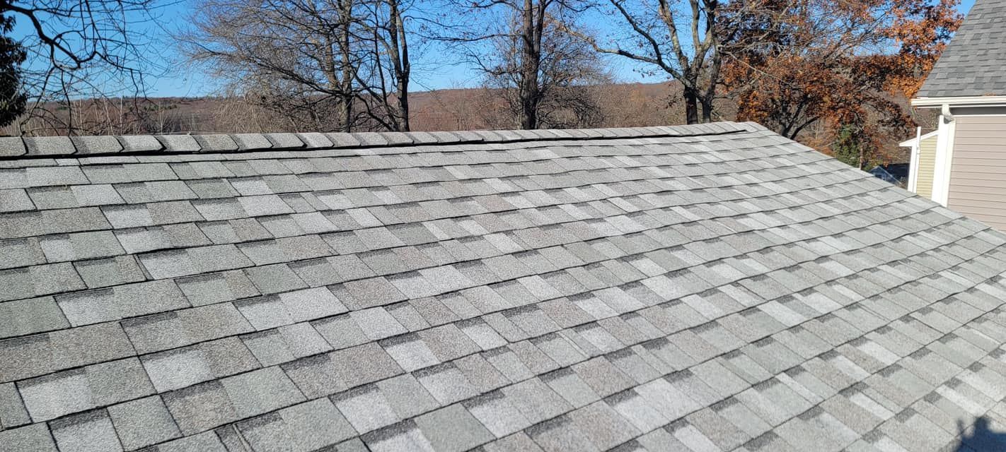 A close up of a roof with a lot of shingles on it.