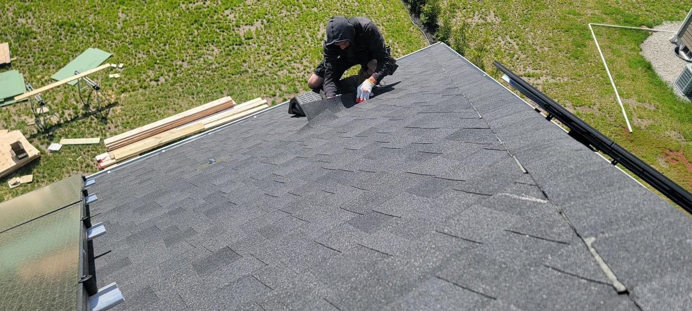 An aerial view of a man working on a roof.