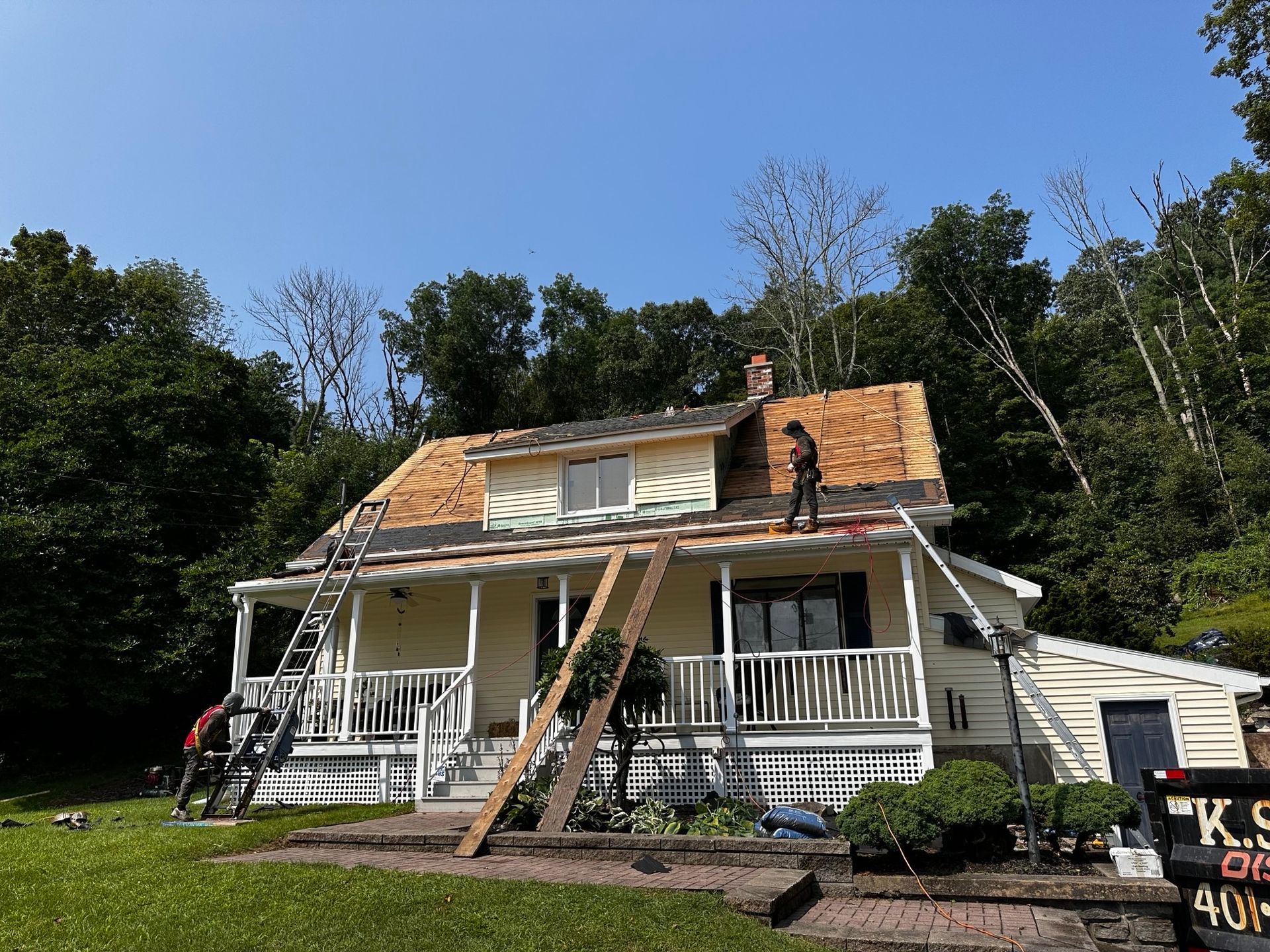 A man is working on the roof of a house.