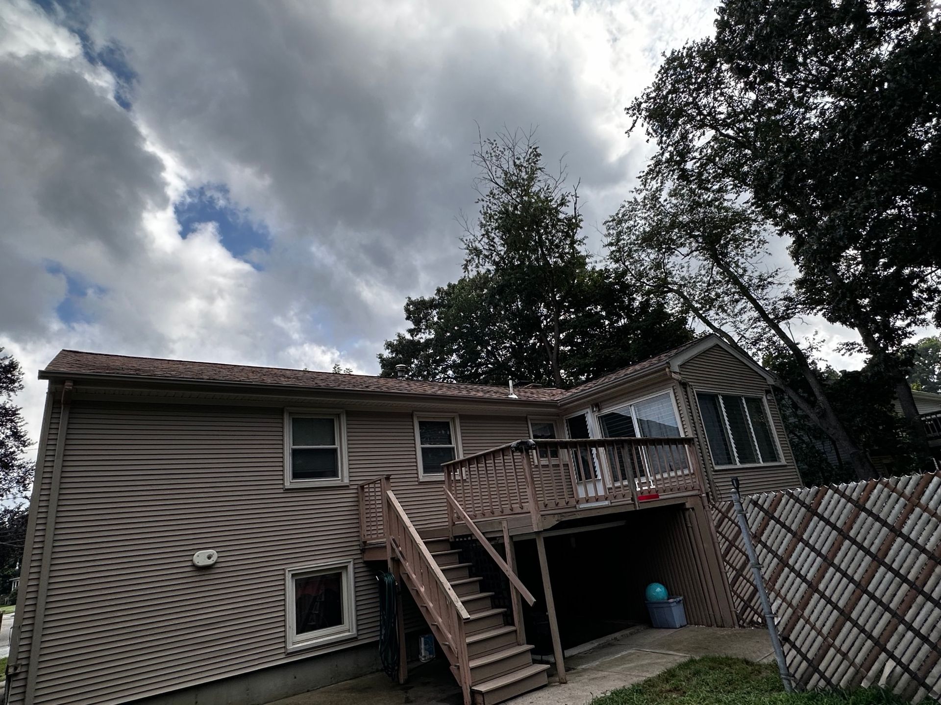 A house with a large deck and stairs leading up to it