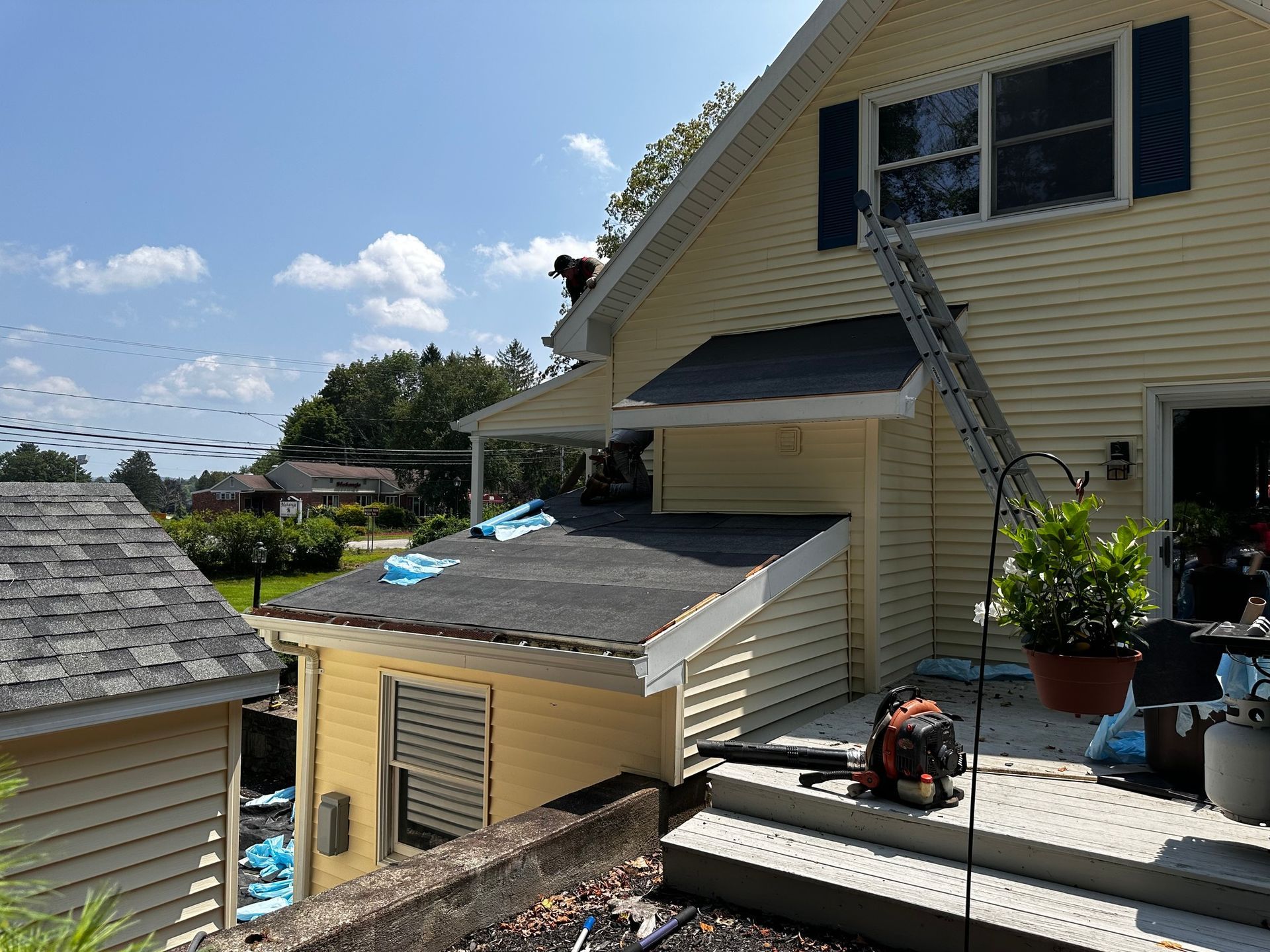 A man is working on the roof of a house.