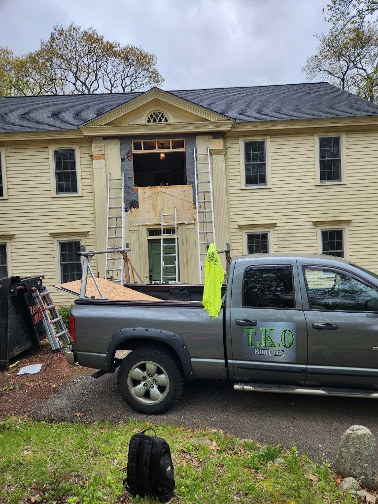 A truck is parked in front of a house under construction.