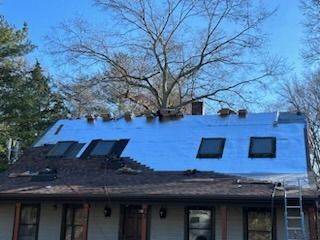 A house with a roof that is being repaired.