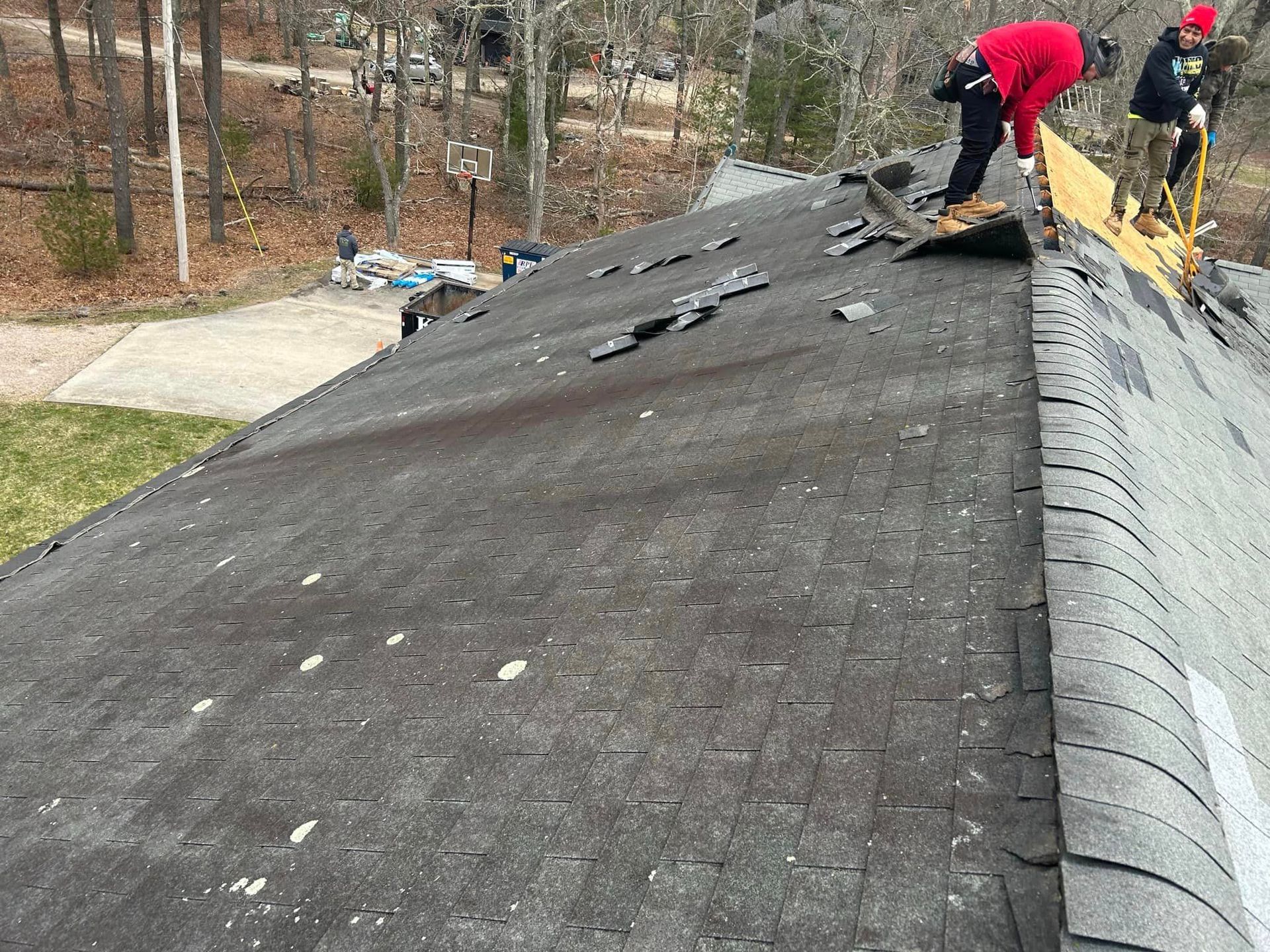 A group of people are working on a roof.