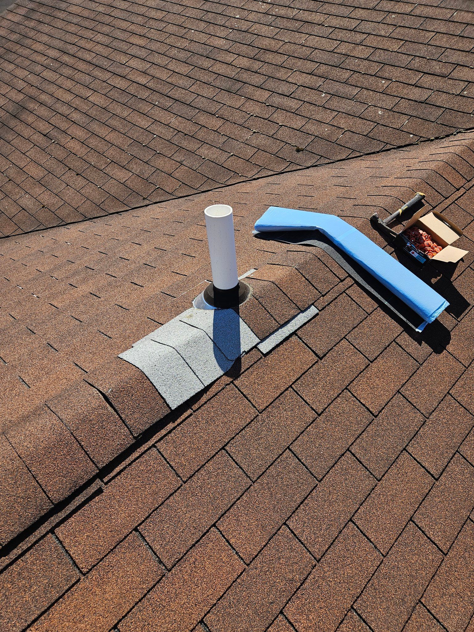 A blue bench is sitting on top of a brick roof.