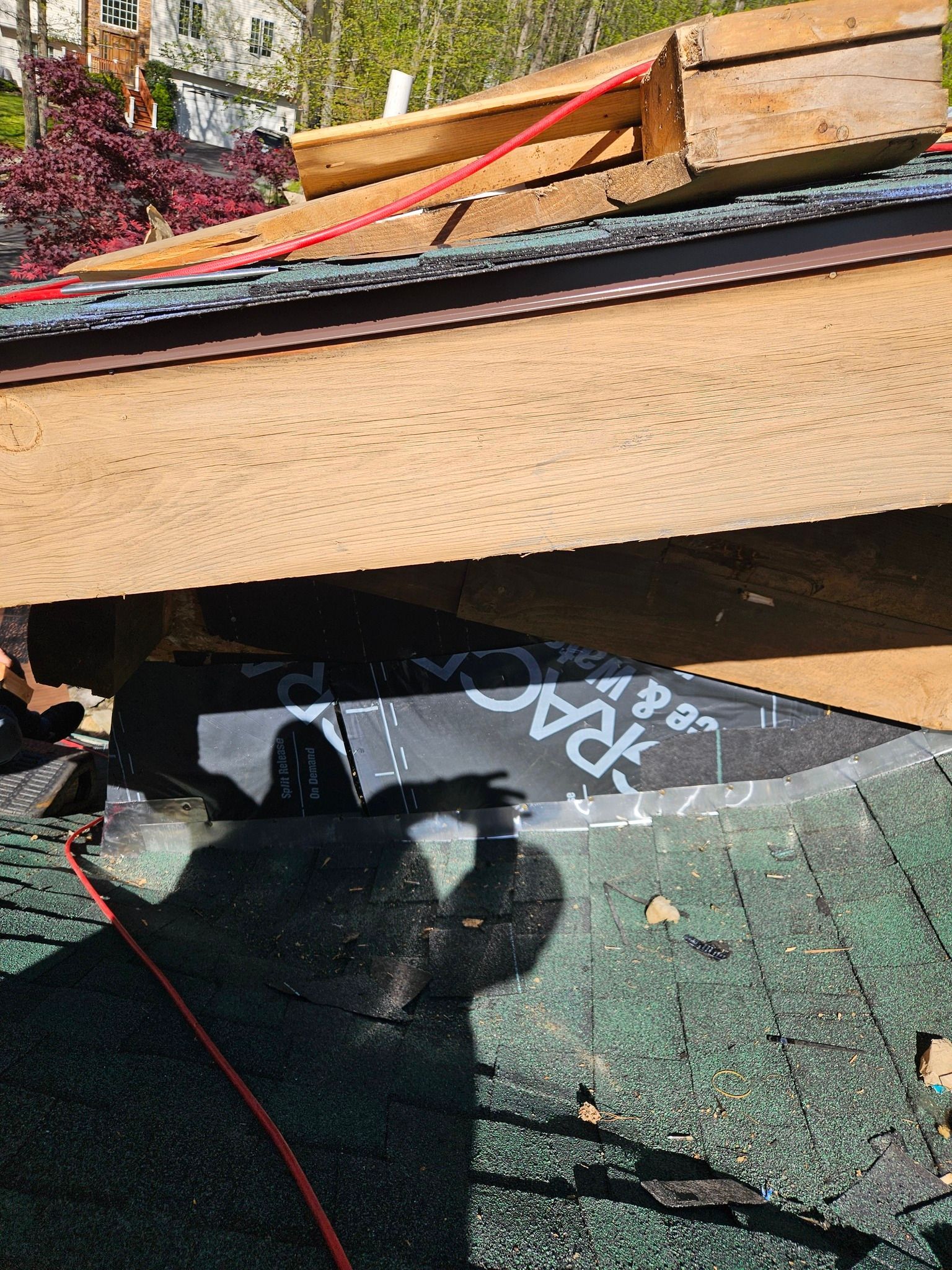 A shadow of a person is casting on a roof.