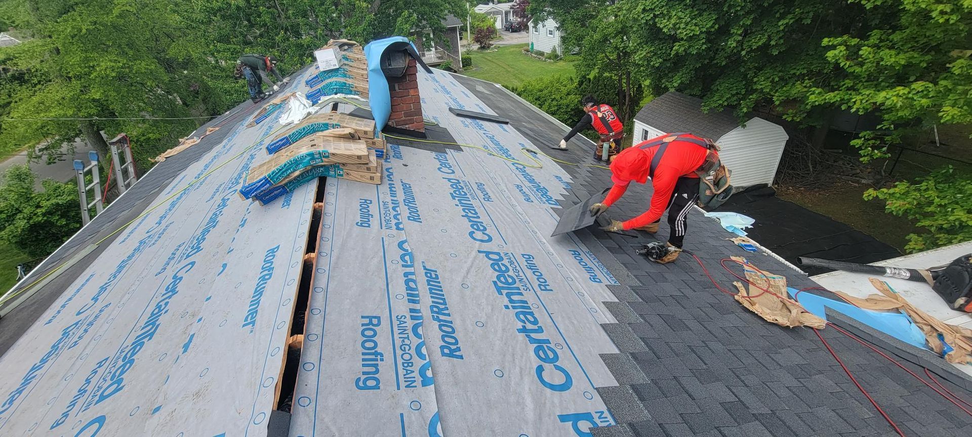 A group of people are working on a roof.