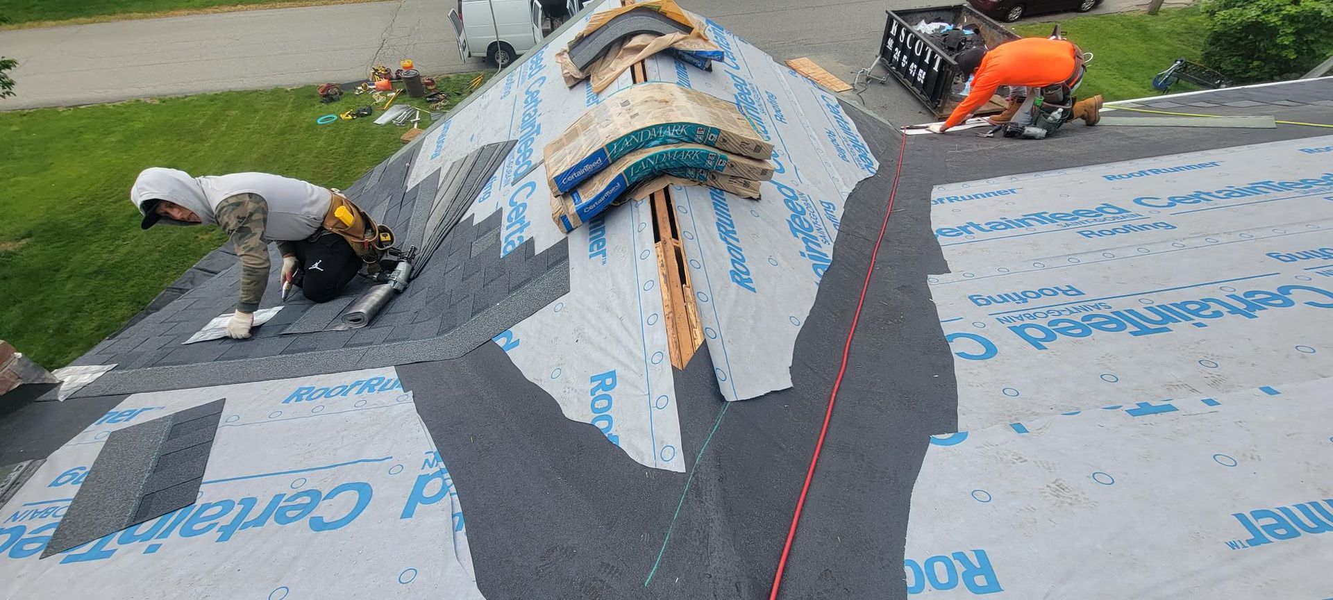 A group of people are working on a roof.
