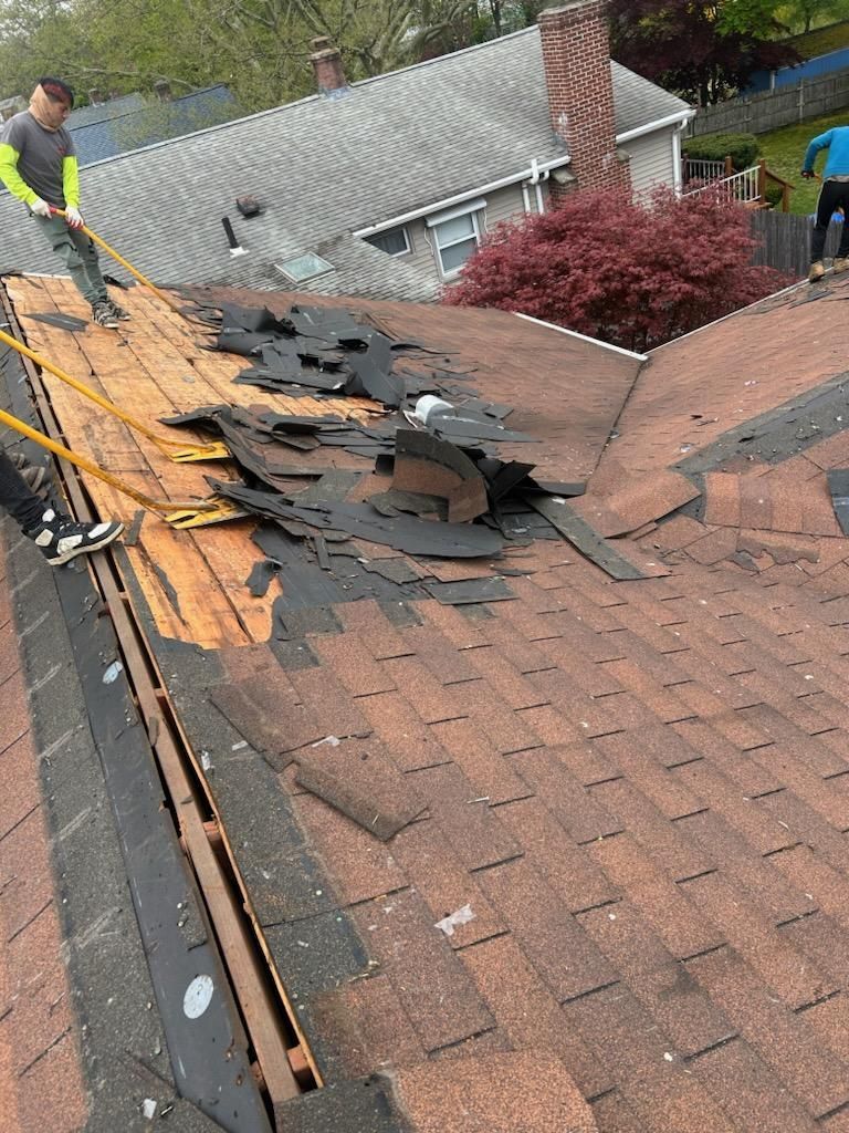 A man is working on the roof of a house.
