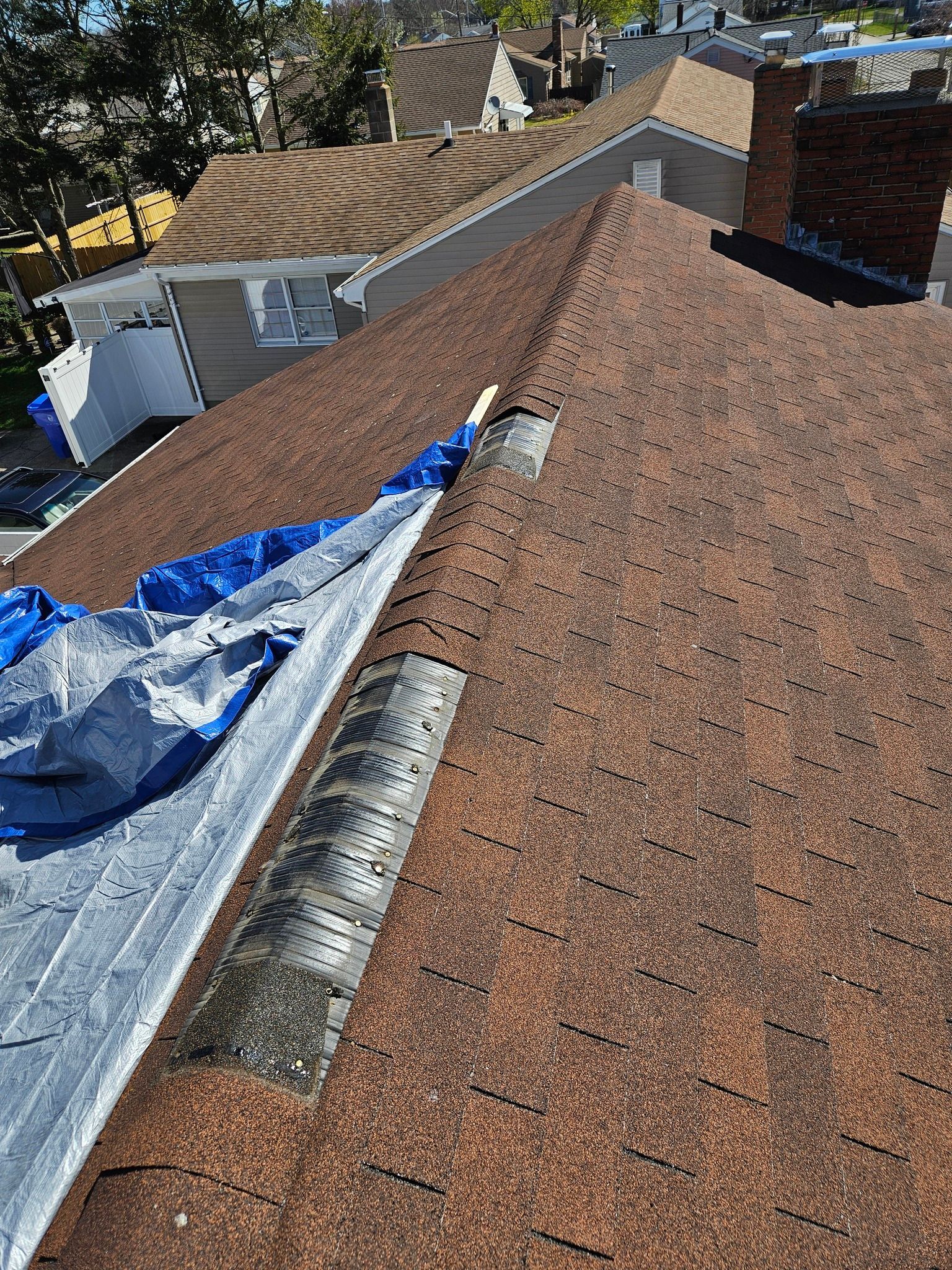 A close up of a roof with a tarp on it.