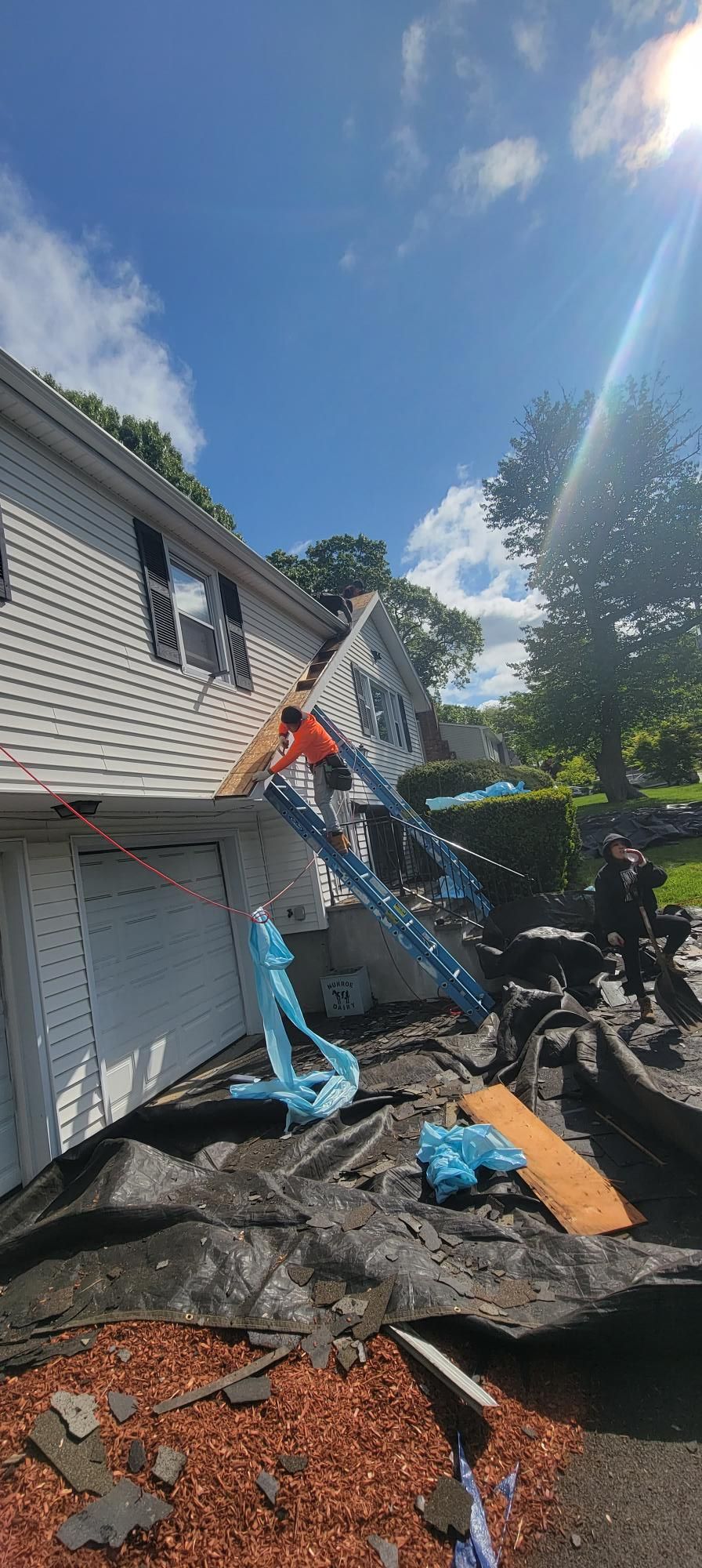 A man is working on the roof of a house.