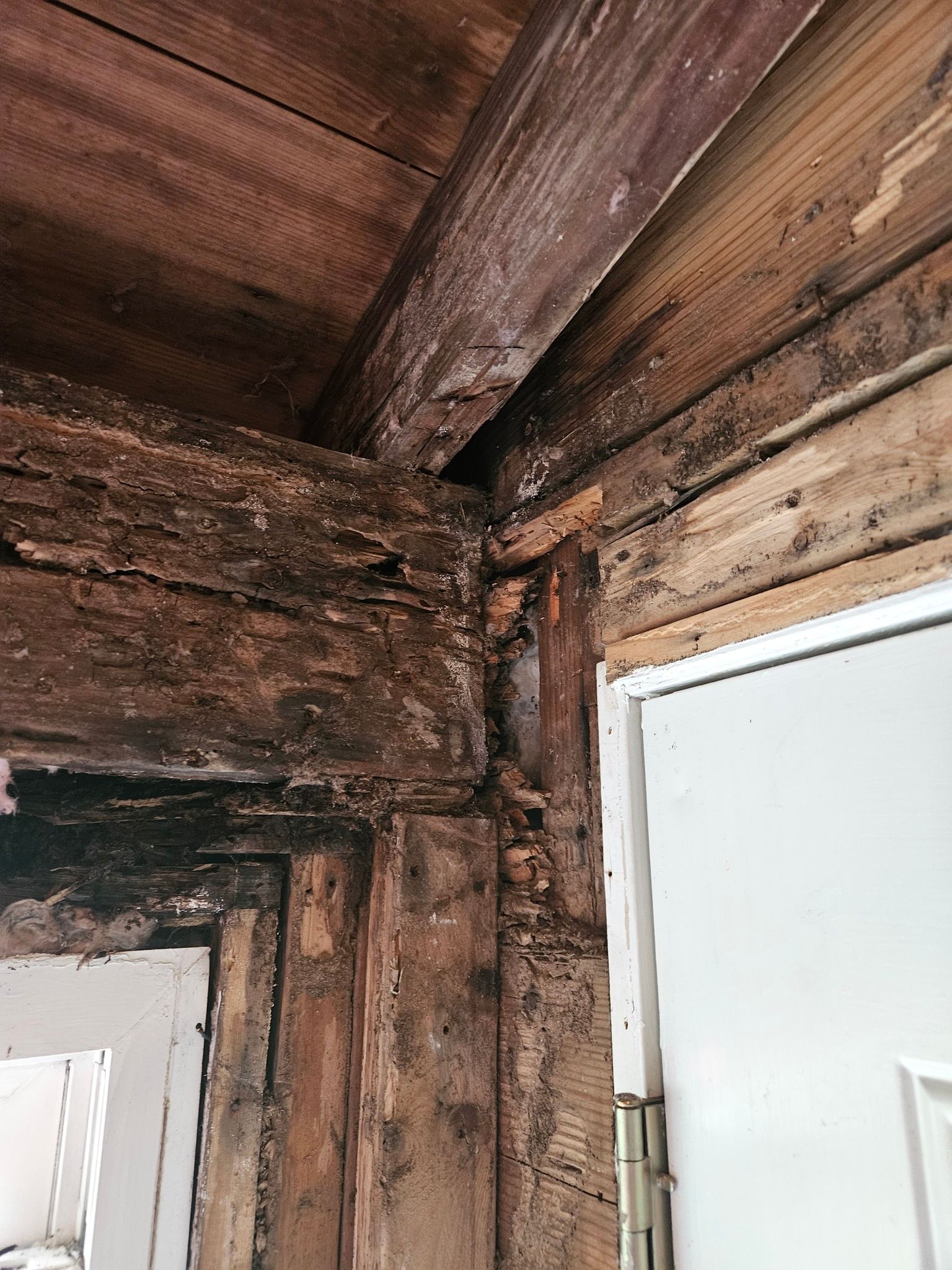 A close up of a wooden wall next to a door.