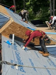 A group of men are working on a roof.