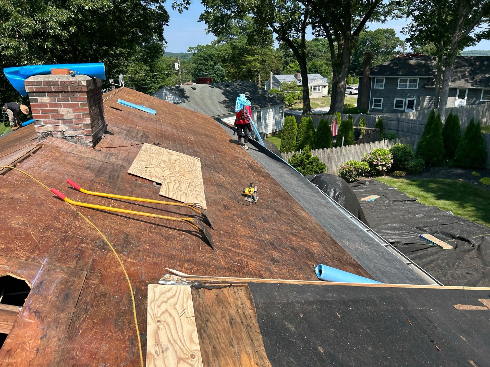 A man is working on the roof of a house.