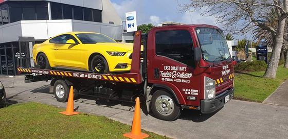Expert loading the car on the towing vehicle