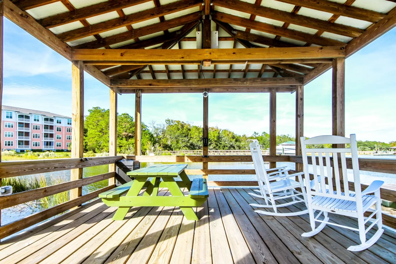 There is a picnic table and rocking chairs on the deck.