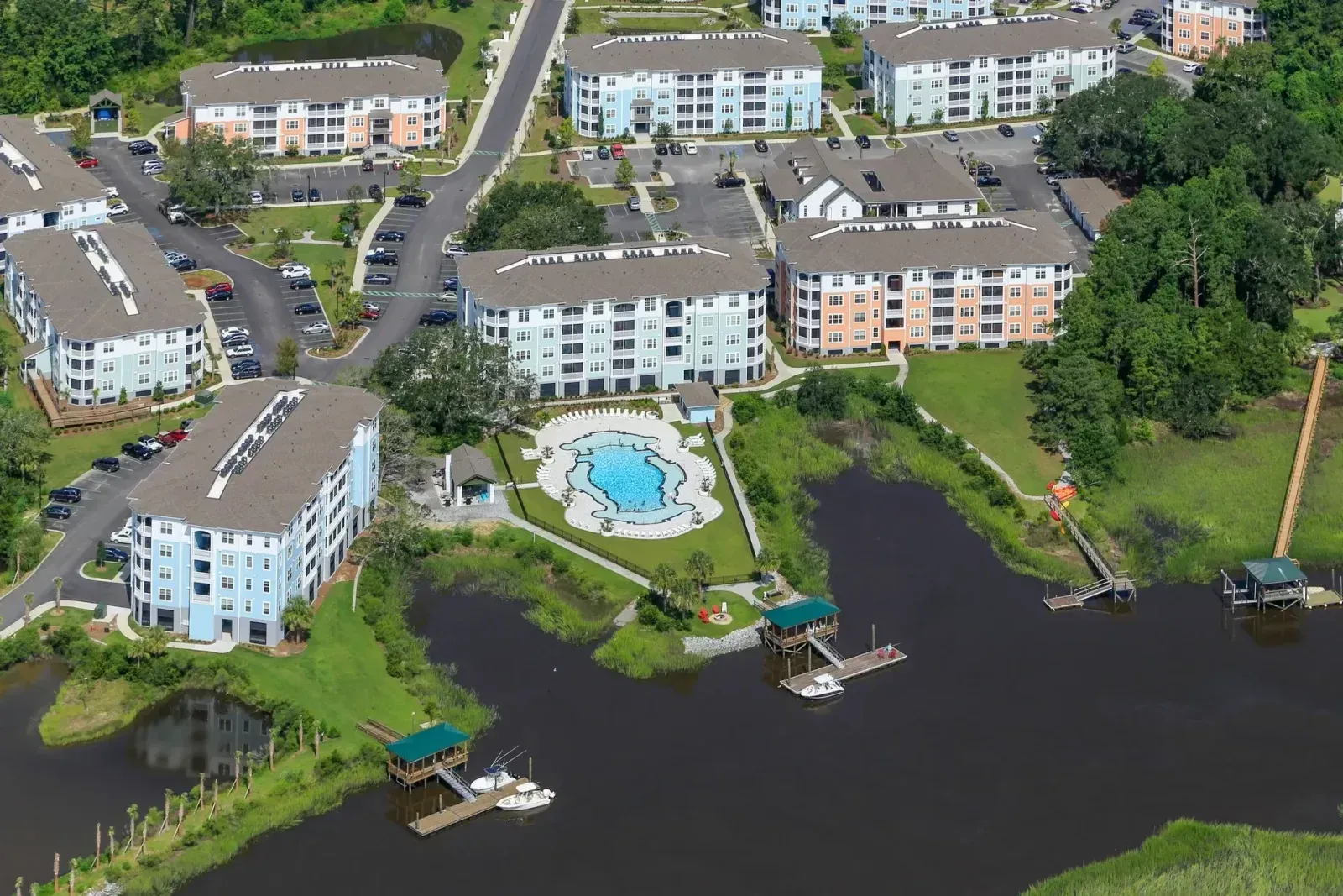 An aerial view of a lake surrounded by buildings and trees