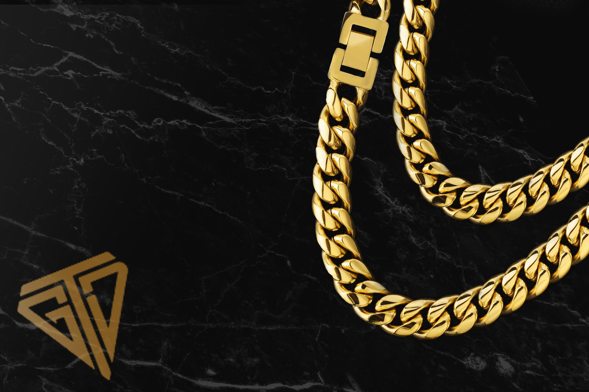 A close up of a gold chain on a black surface