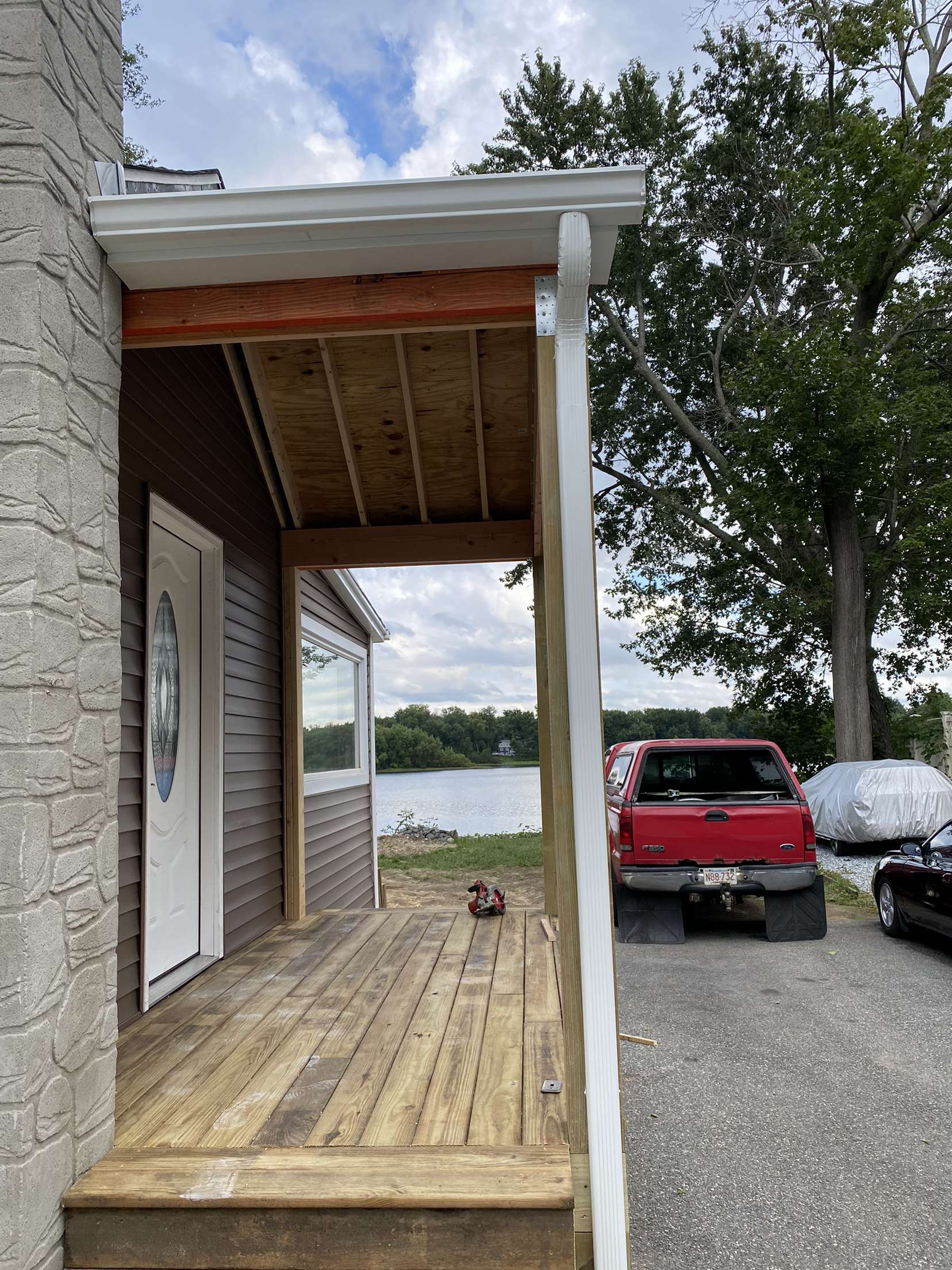 Beautiful white downspout on front porch of home fitted to keep the rain away.