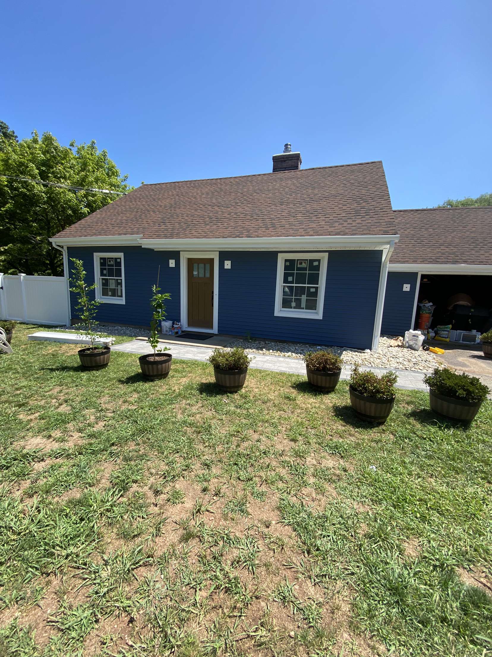 Little blue house received white gutters to compliment the exterior in Southampton, MA