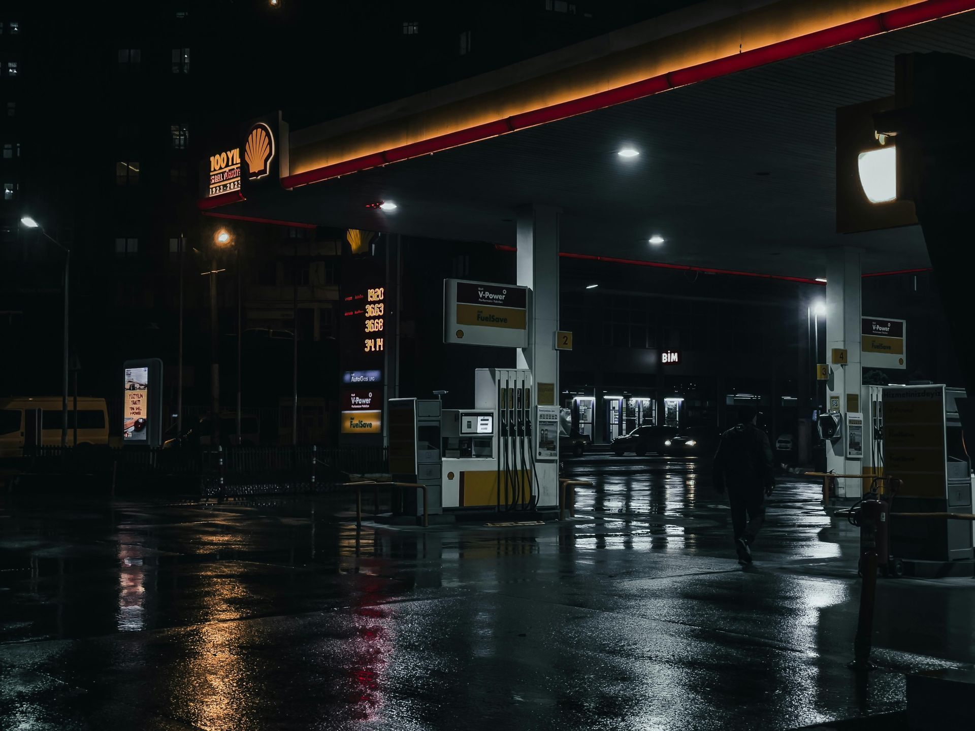 Workers smoothing wet concrete for a sidewalk with hand tools in an outdoor setting.