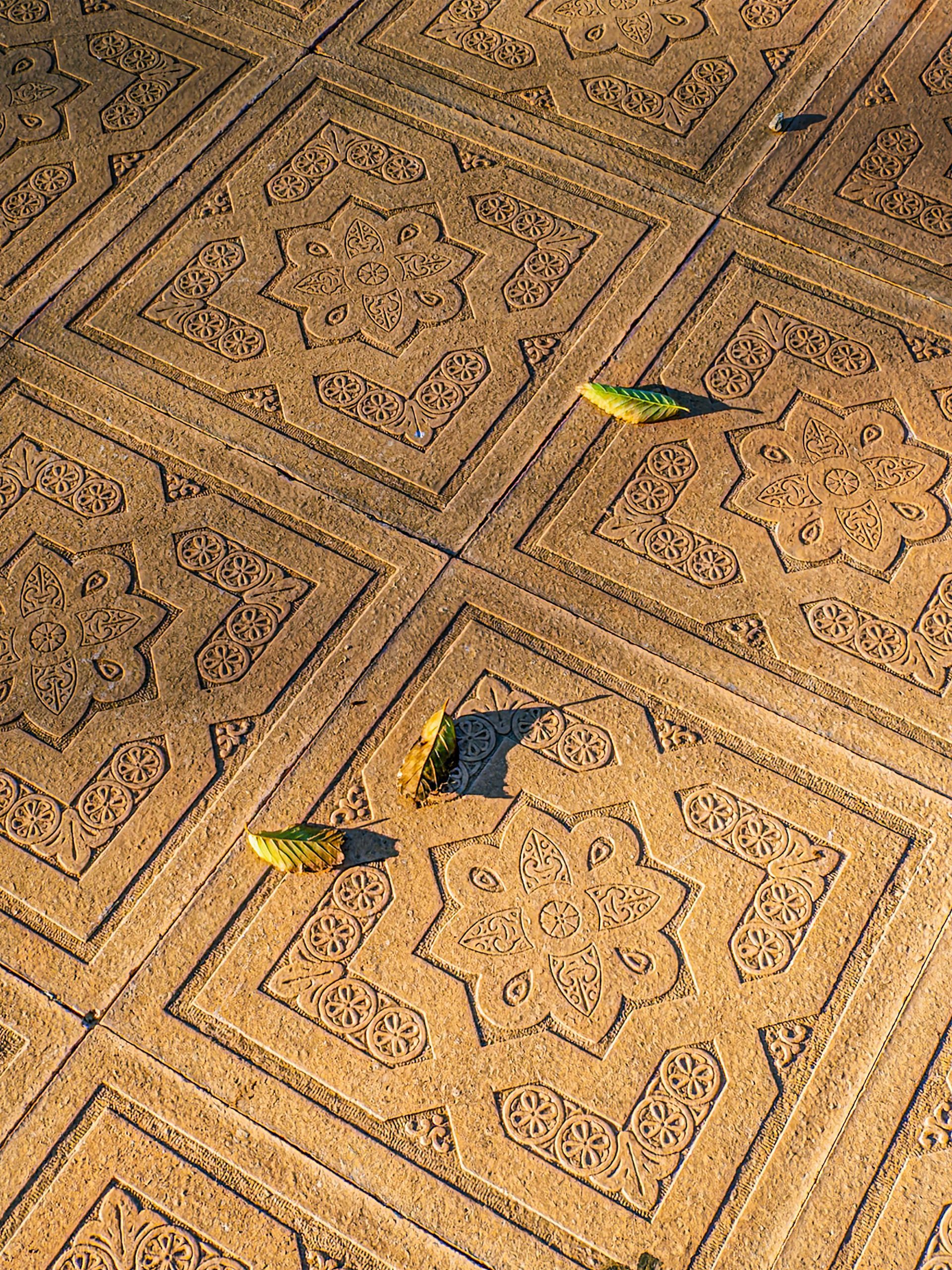 Construction workers pouring concrete on a road, wearing safety vests, boots, using shovels.