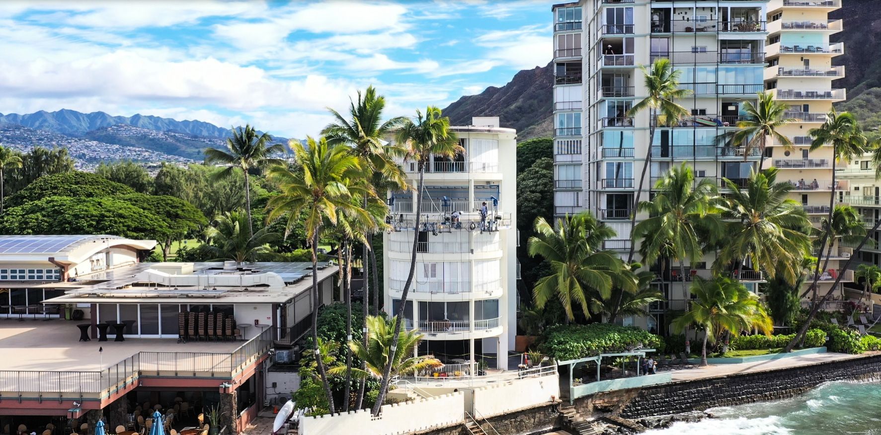 Oceanfront Honolulu condominium with crews performing exterior railing and renovation work by Seal Masters of Hawaii