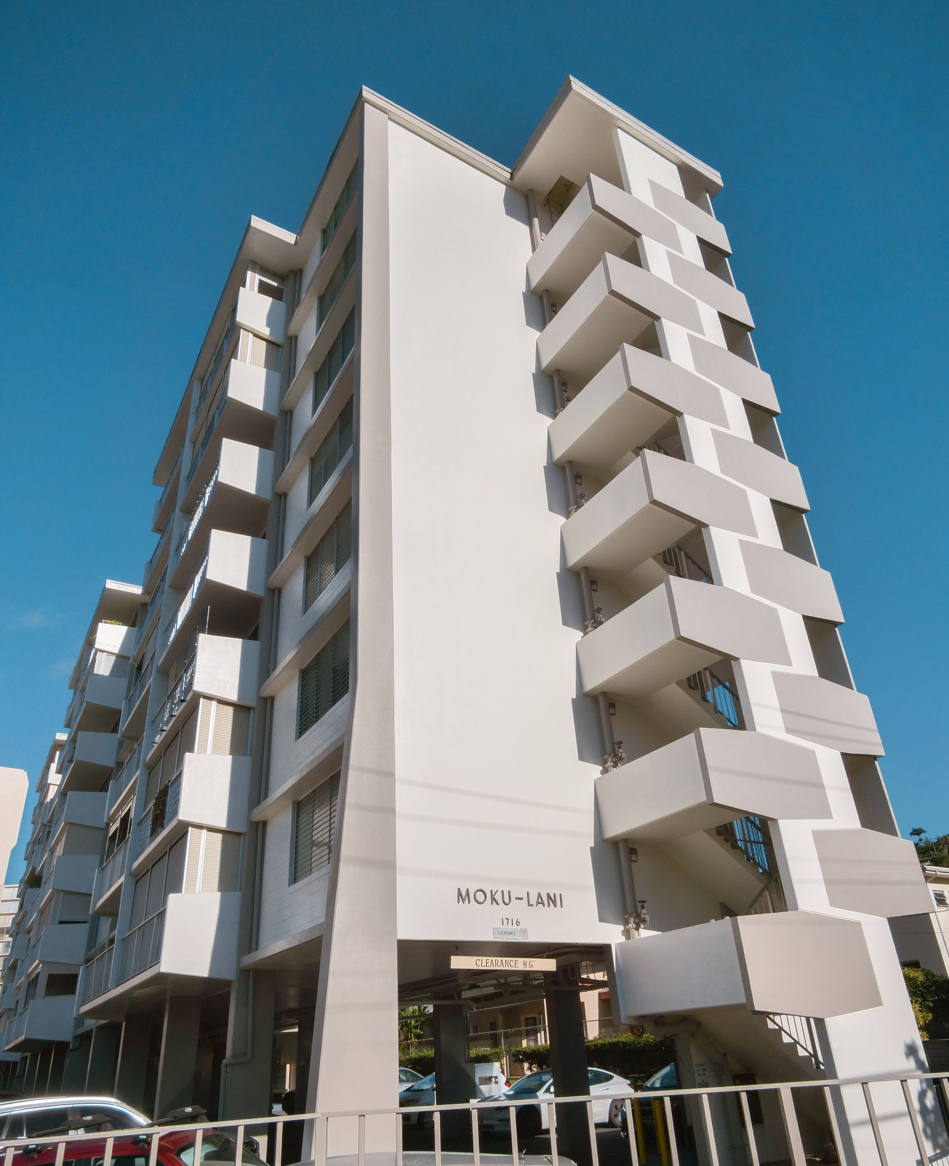 Looking up at a tall building with a blue sky in the background