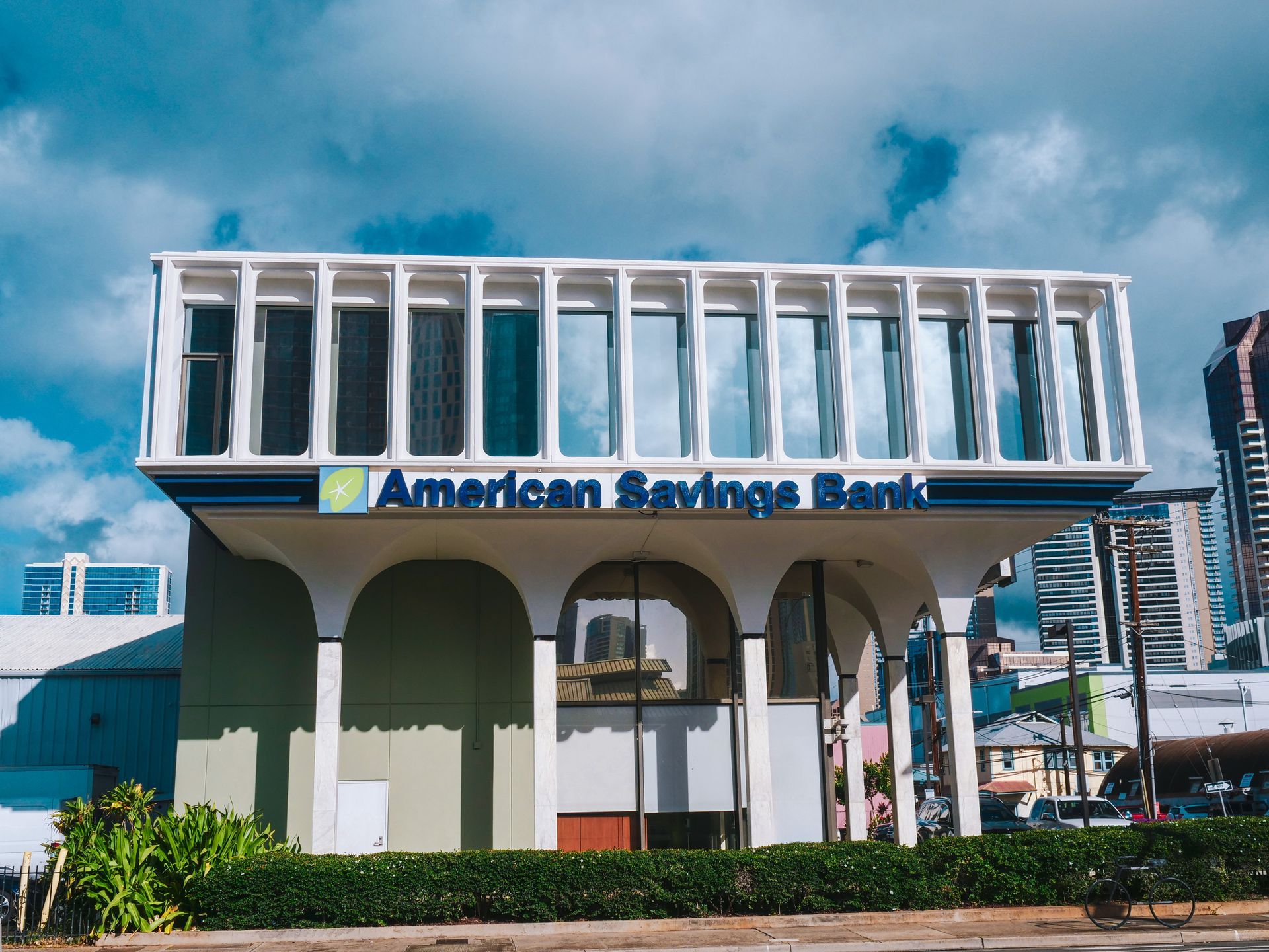 A large white building with a blue sign that says american savings bank.
