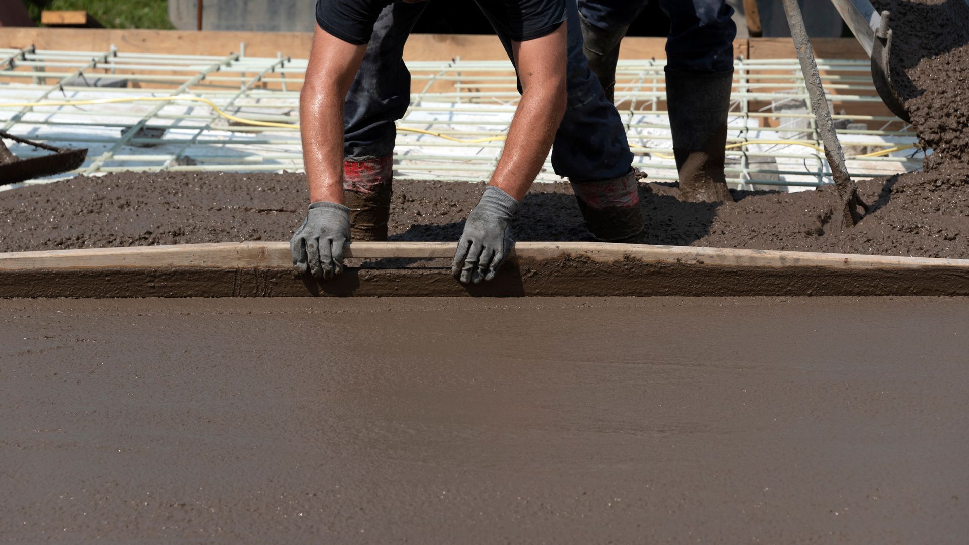 A worker is floating a concrete surface