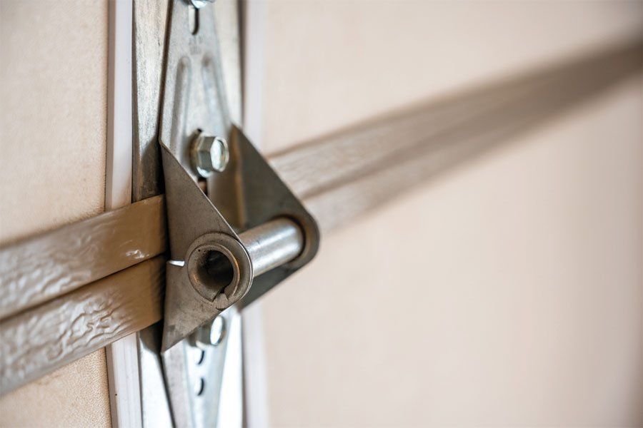 A noisy garage door in Maple Grove, IL because of broken or rusted hinges.