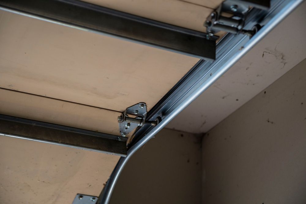 a close up of garage door rollers with the door open .