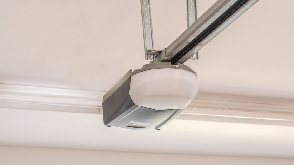 A close up of a garage door opener hanging from the ceiling.