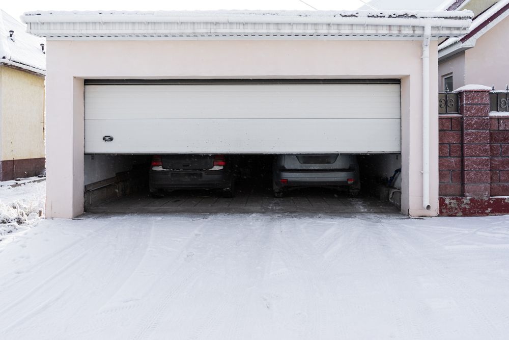 A house with a garage door that is stuck halfway.