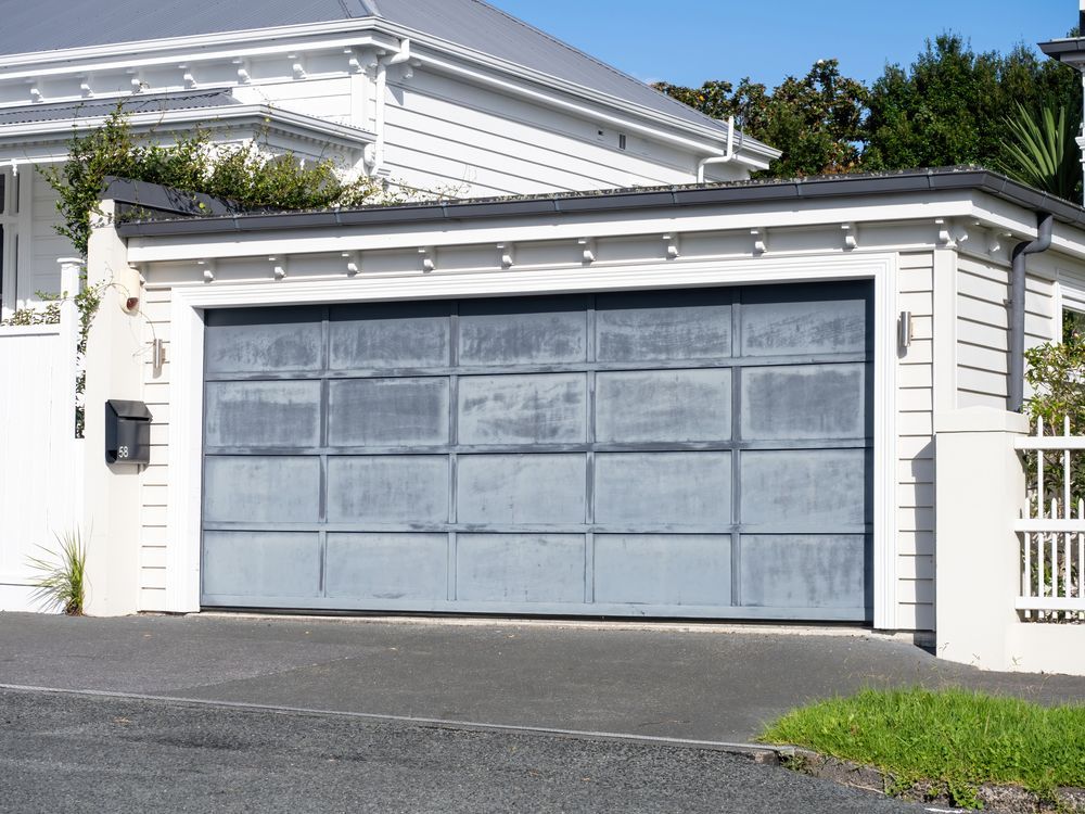 A white house with a blue garage door