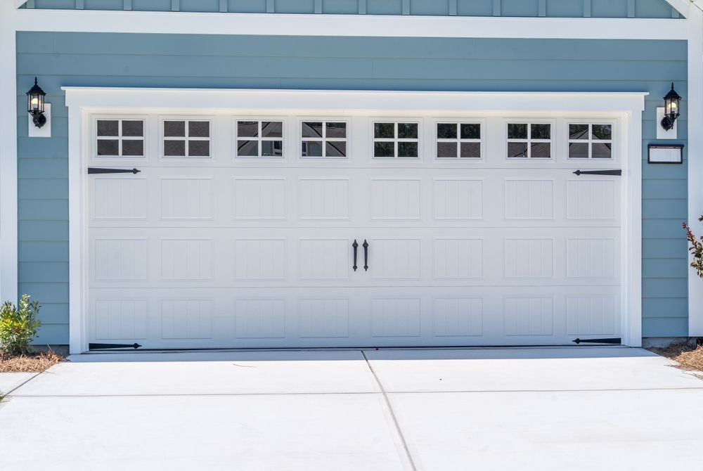 A new/updated white garage door with windows.