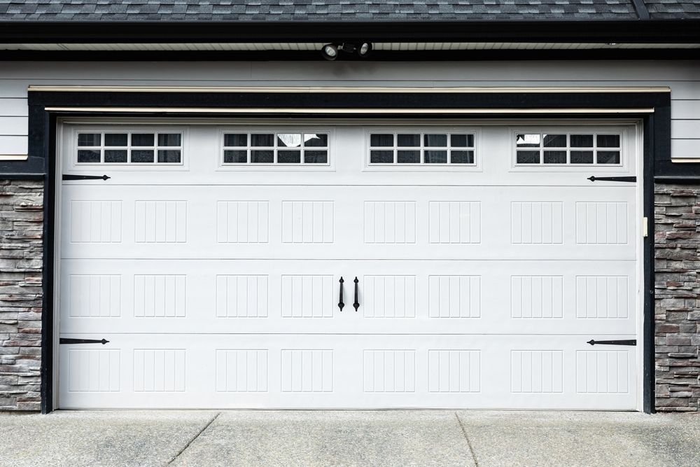 A stylish white garage door that enhances the home's curb appeal.
