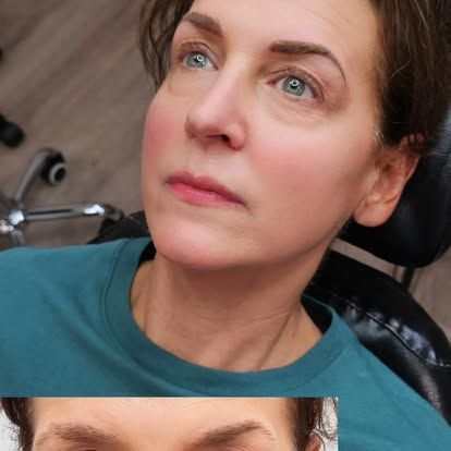 Woman with soft makeup looks up, in a salon setting. Blue eyes, rosy cheeks, and brown eyebrows.