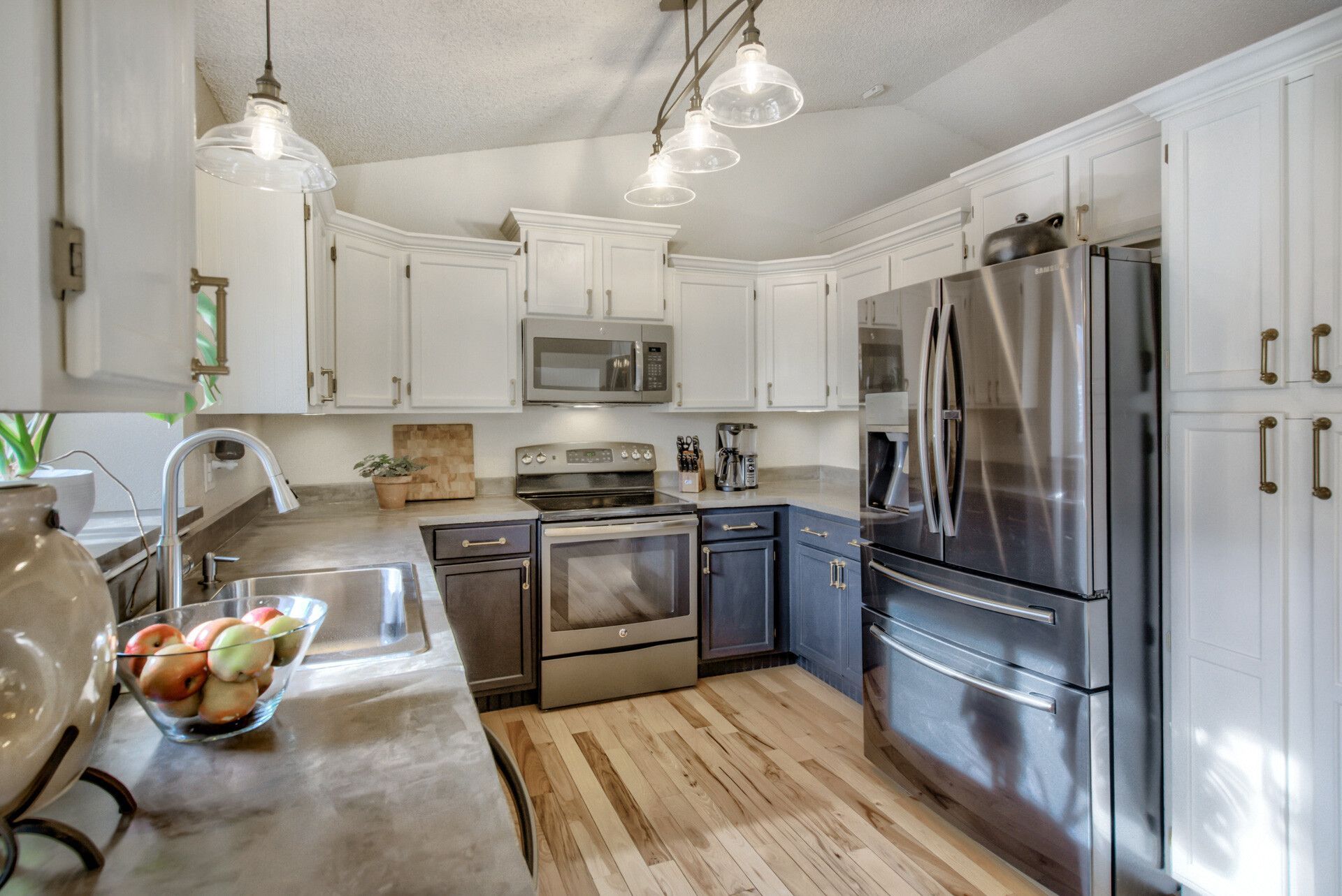A kitchen with stainless steel appliances and white cabinets