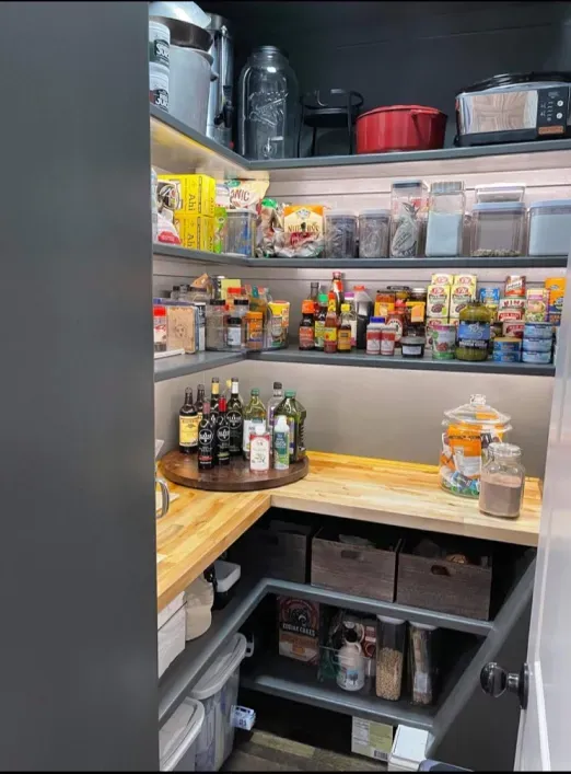 A pantry filled with lots of food and bottles.