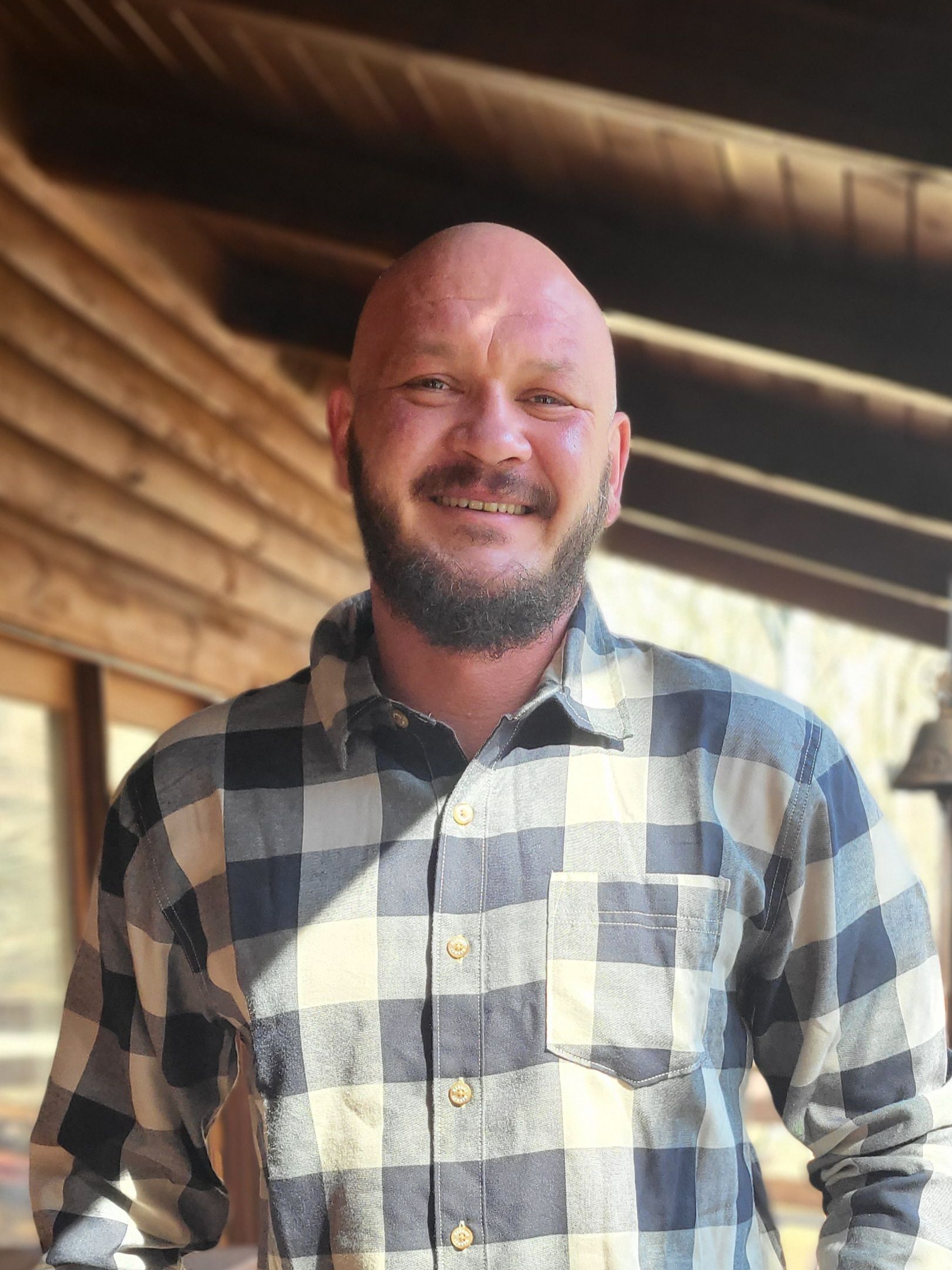 A white house with a wooden gazebo in front of it