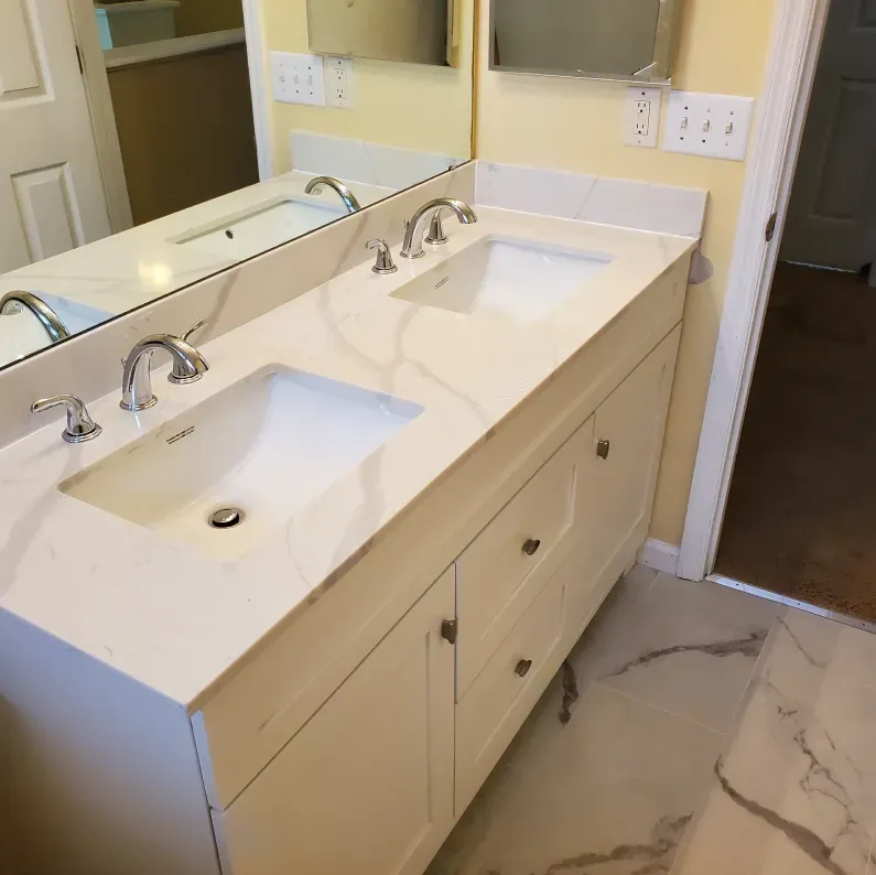 A bathroom with two sinks and a mirror