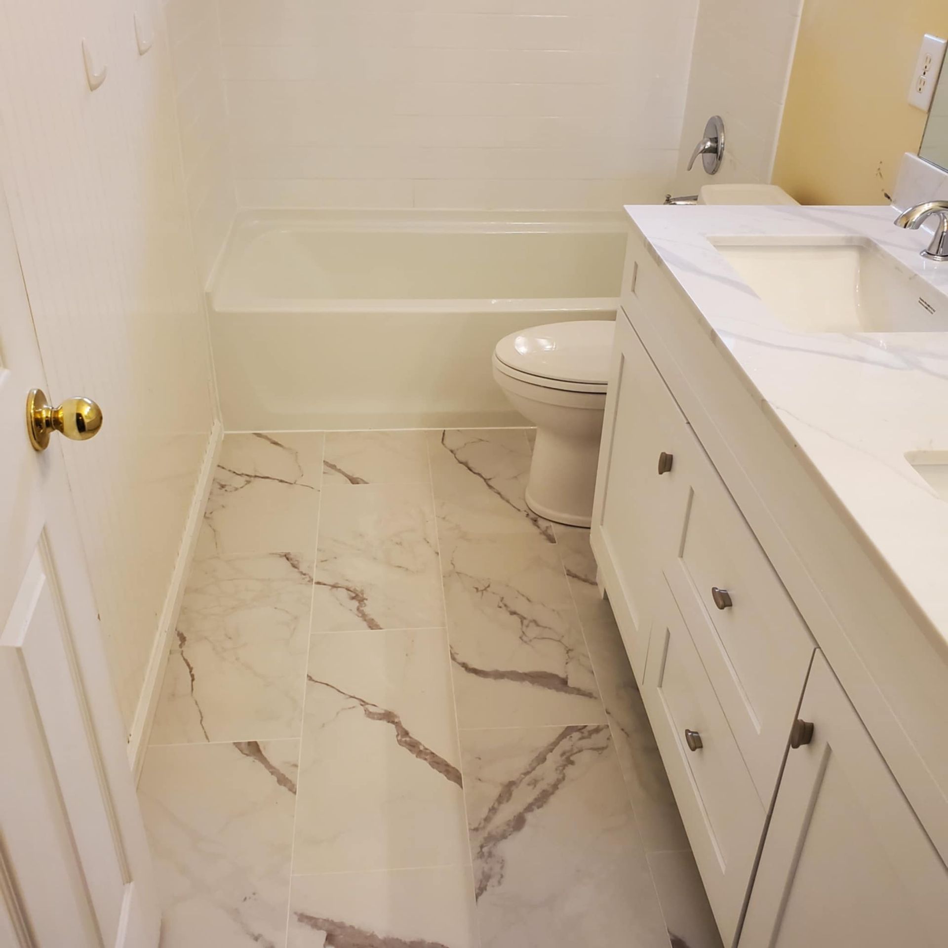 A bathroom with a toilet a sink and a bathtub