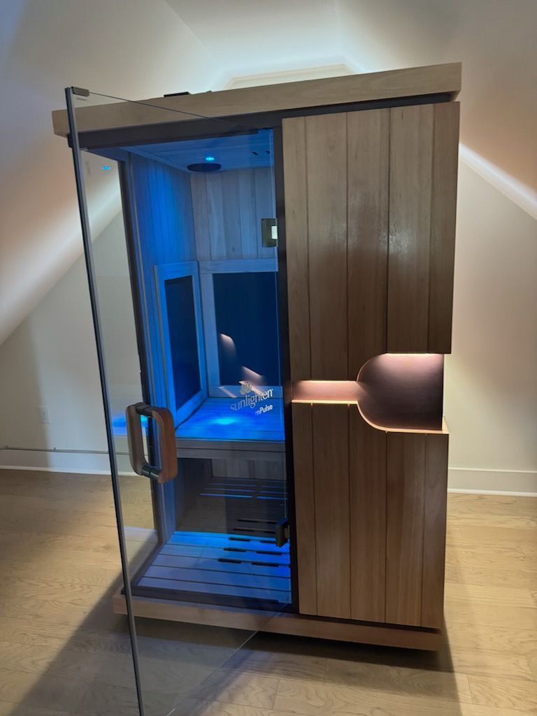A small wooden sauna with a glass door