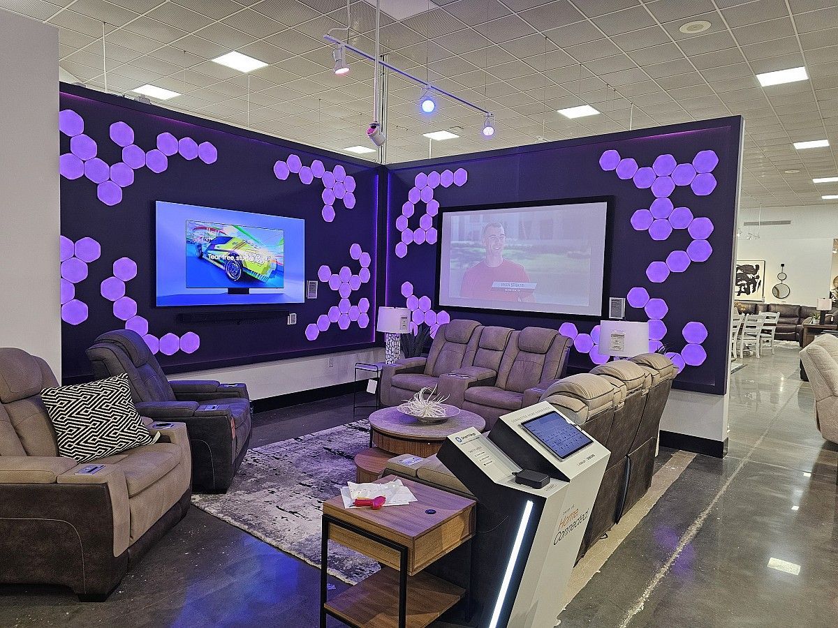 A living room filled with furniture and a projector screen.