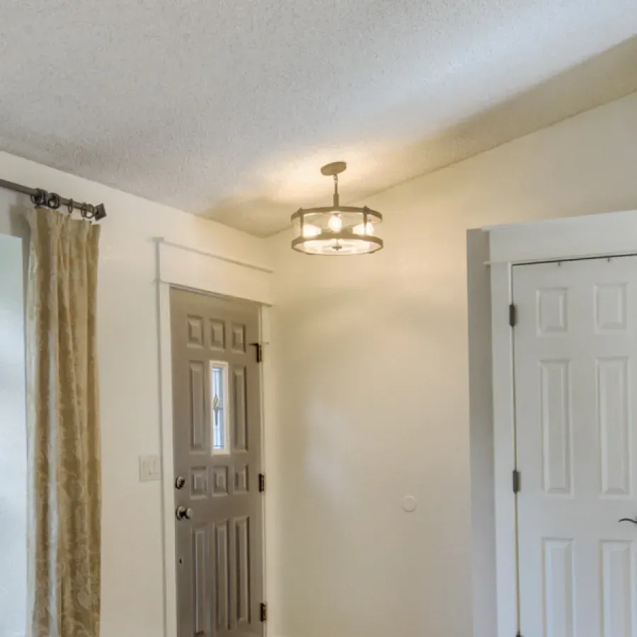 A room with a door and a light on the ceiling