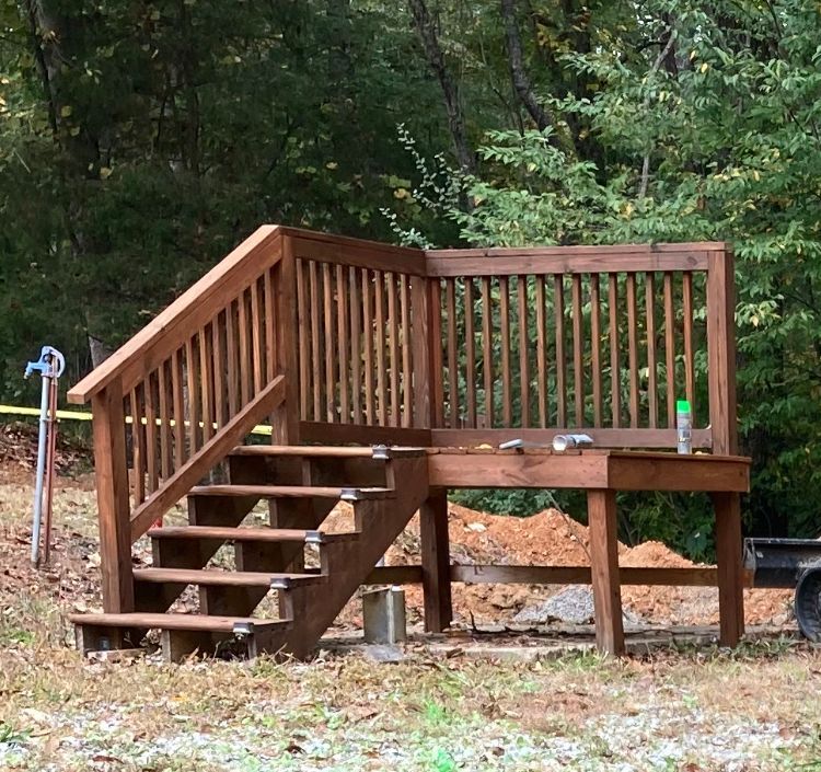 A wooden deck with stairs leading up to it