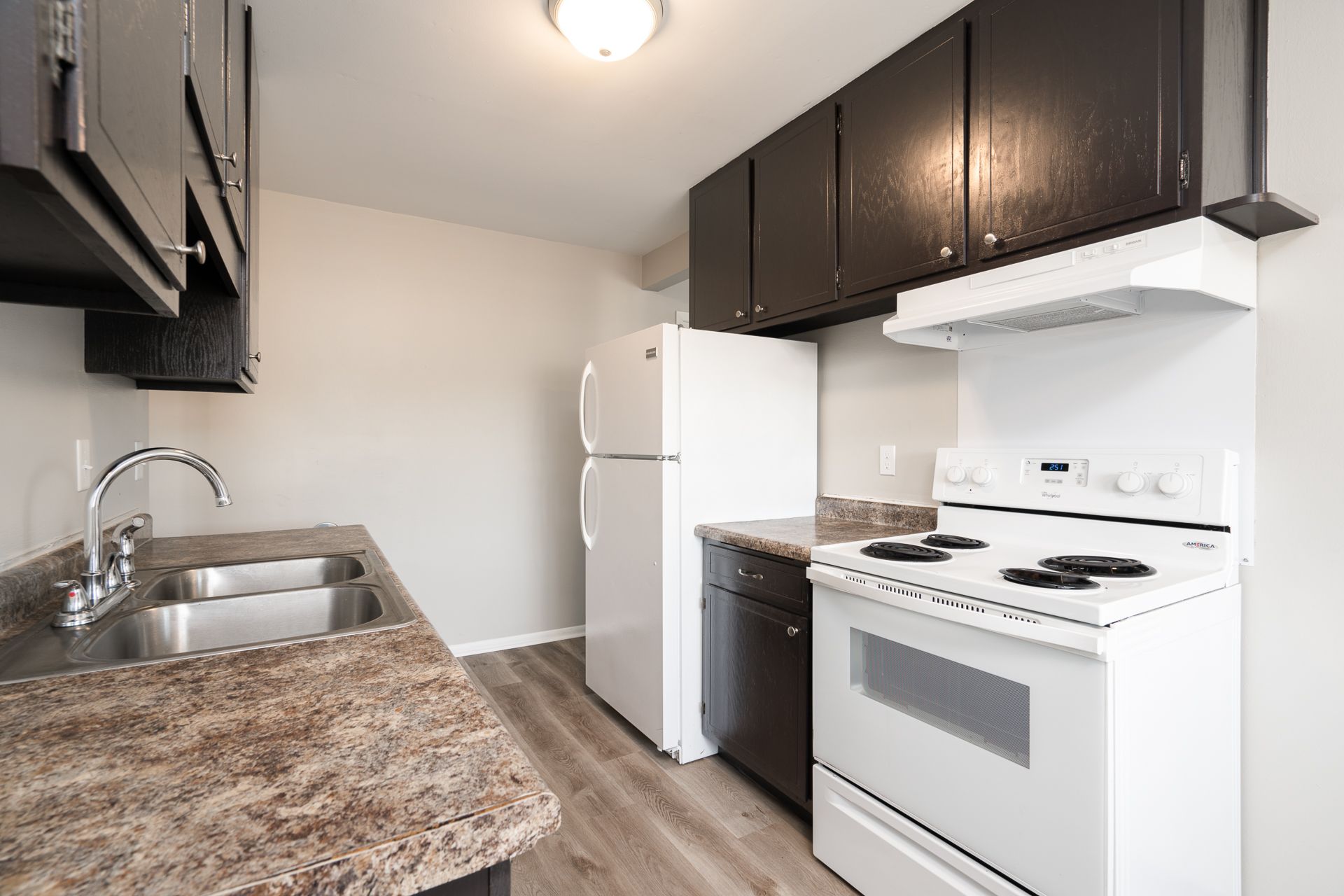 A kitchen with a stove , refrigerator , sink and dishwasher.