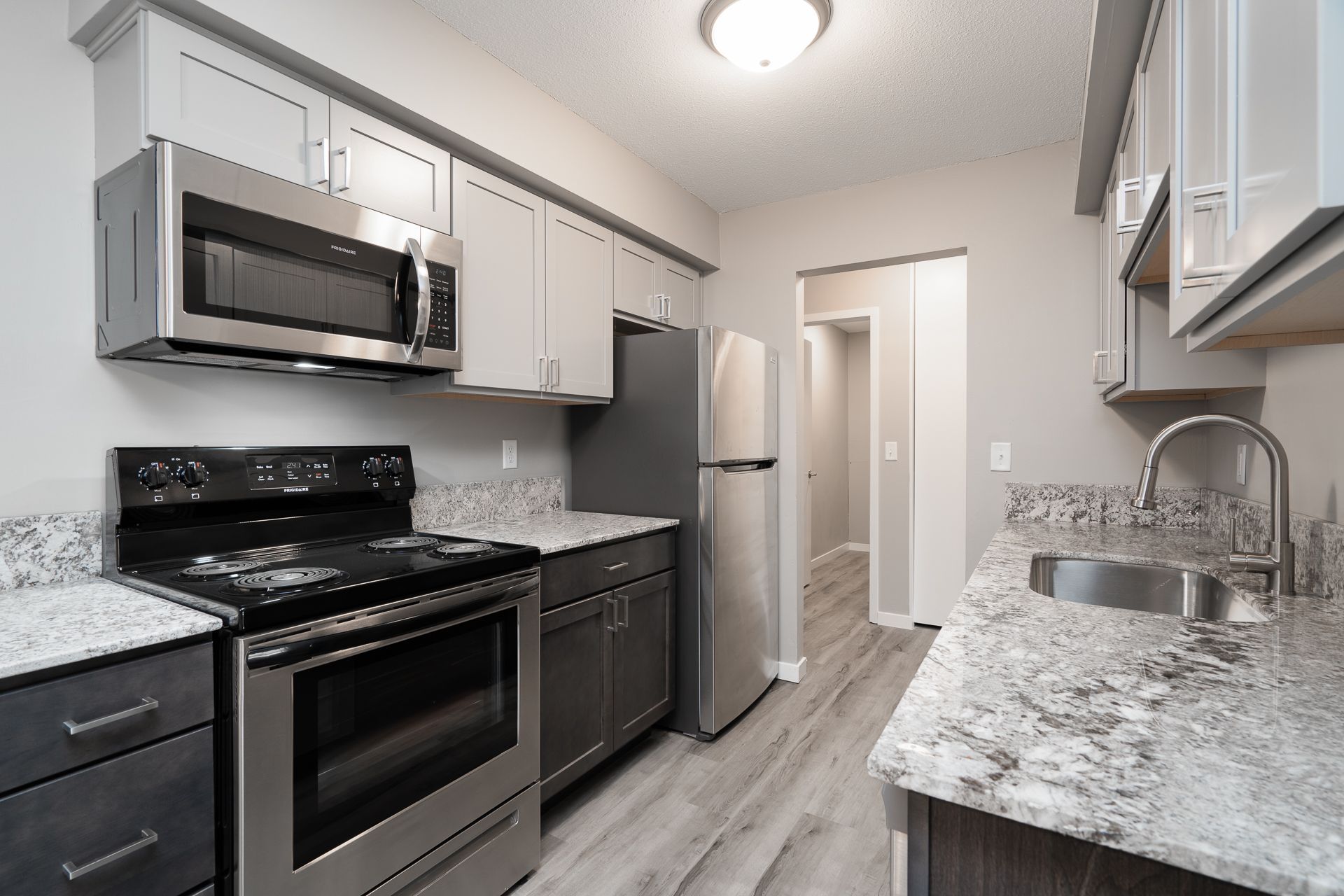 A kitchen with stainless steel appliances and granite counter tops